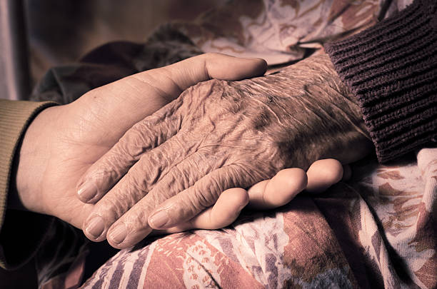 istock girl's hand holds an old woman's hands 493305798