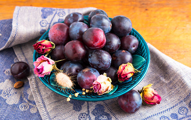 istock Purple plums in a green plate 493306206