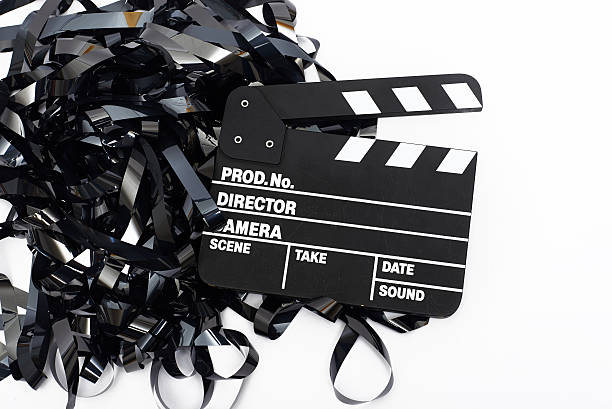 istock Movie clapper board with video tape on white background 493306222