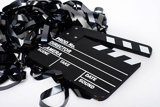 istock Movie clapper board with video tape on white background 493306286