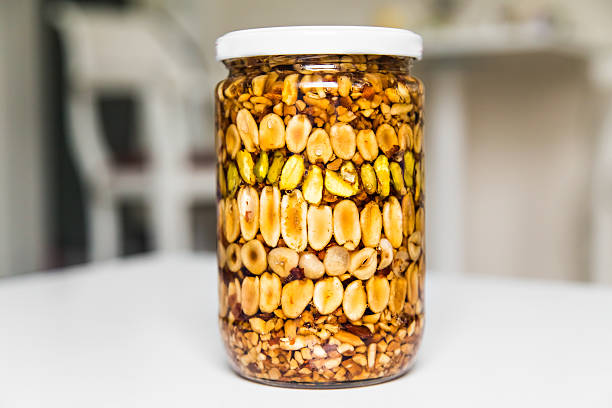 istock Honey in the pot with nuts 493307866