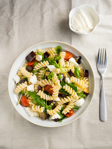 roasted vegetable with pasta and mozzarella cheese and water cress and rocket leaves.