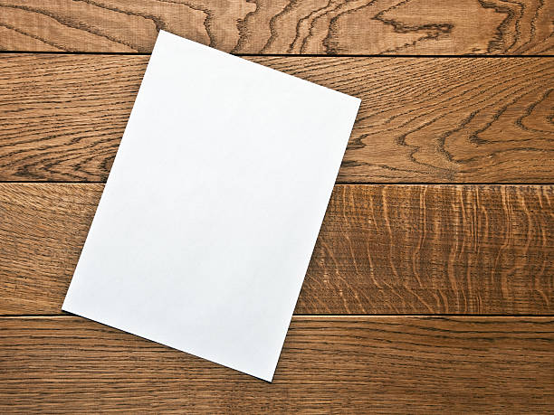 istock blank sheet of paper on a wooden table 493310570