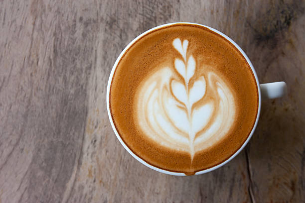 istock hot milk art coffee on wooden table 493311540