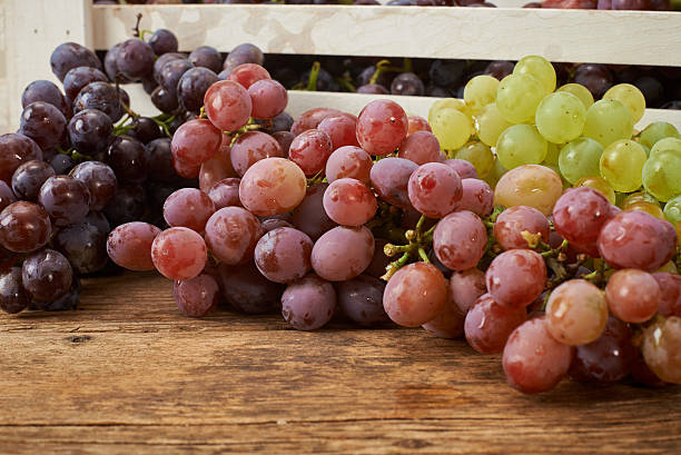 istock bunch of fresh grapes on wooden kitchen bench 493311606