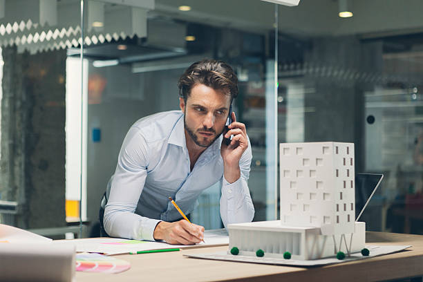 istock Designer talking on smart phone in office. 493311942