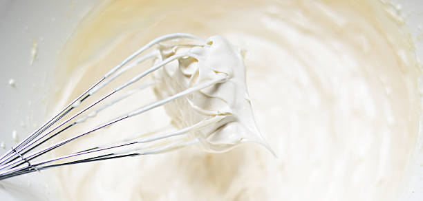 istock Whipping cream with a whisk close up 493311954