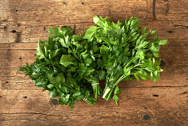 istock bunches of fresh celery on wooden bench 493313144