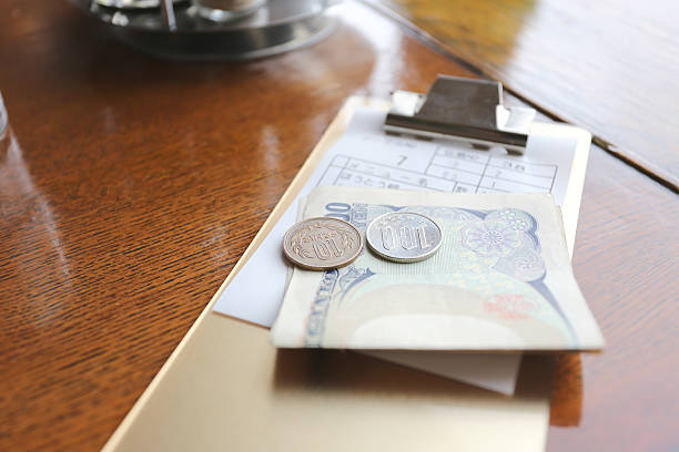 The money of Japan (Yen). The money of Japan (Yen) and bill for meals on the table in a restaurant. japan restaurant bill stock pictures, royalty-free photos & images