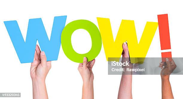 Multiethnic Hands Holding Text Wow With Exclamation Point Stock Photo - Download Image Now