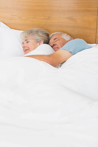 loving couple senior chambre - couple affectionate relaxation high angle view photos et images de collection