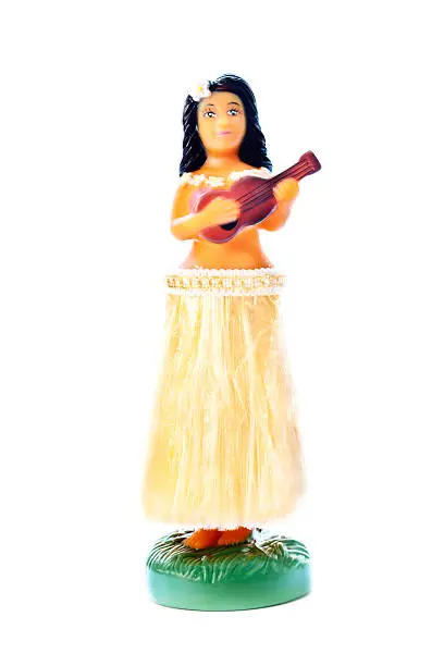 Subject: A hula dancer figurine doll. Isolated in white background.