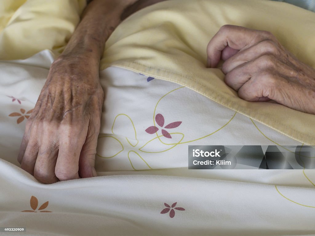 Skinny old hands The hands of a very old and skinny woman in bed Hospital Stock Photo