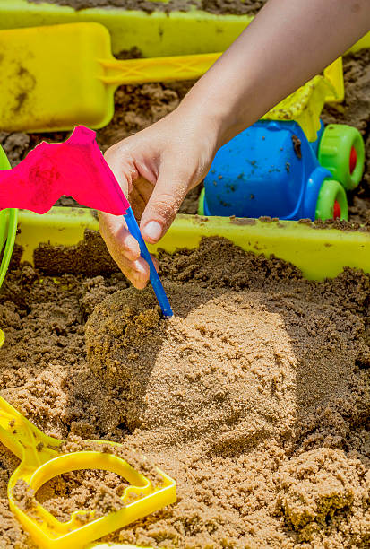 istock child playing in the sand, sand pit, colourful. 493321357