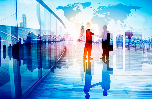 istock Silhouettes of Two Businessman Shaking Hands 493321677