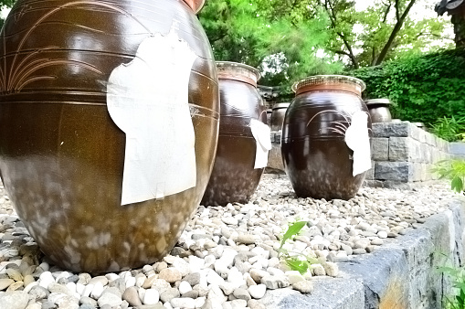 Image of Shishi odoshi on stone canoe with colorful stone cobblestone path in Japanese Tea Garden
