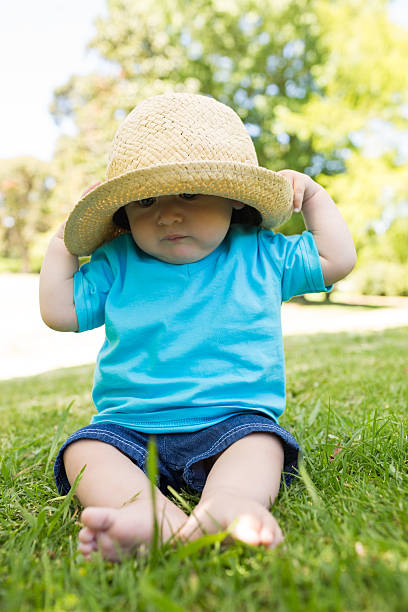 istock Baby boy wearing sunhat in park 493322889