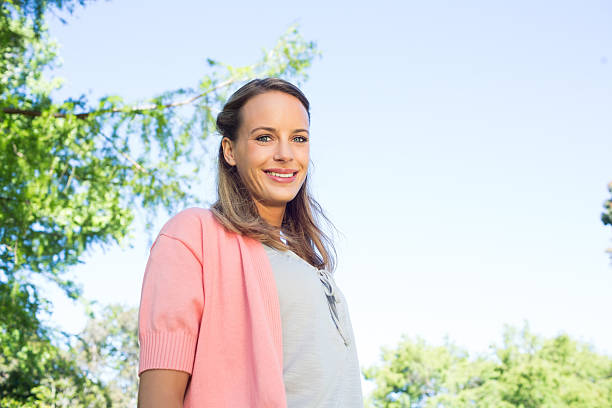istock Woman standing against clear sky at park 493323053