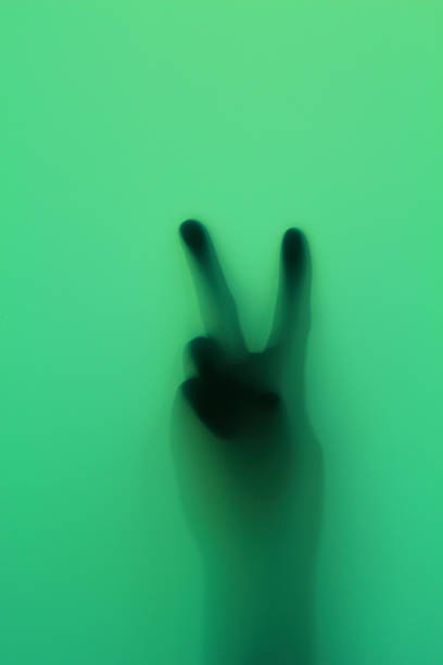 istock Hand silhouette on green glass 493324097