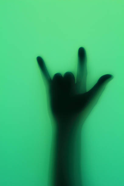 istock Hand silhouette on green glass 493324279