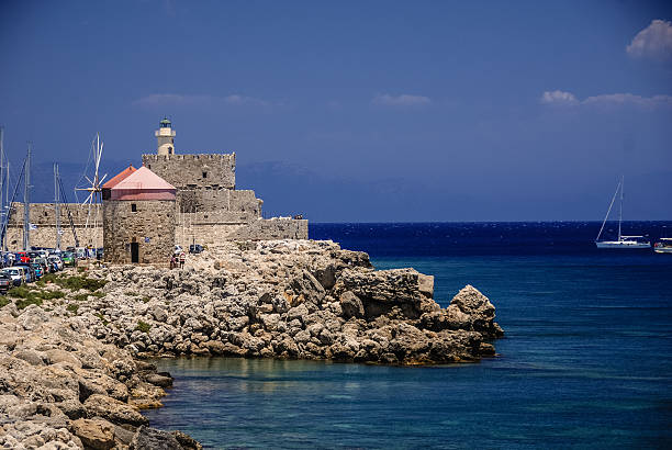 istock Windmills and the Lighthouse at Rhodes, Greece. 493325227