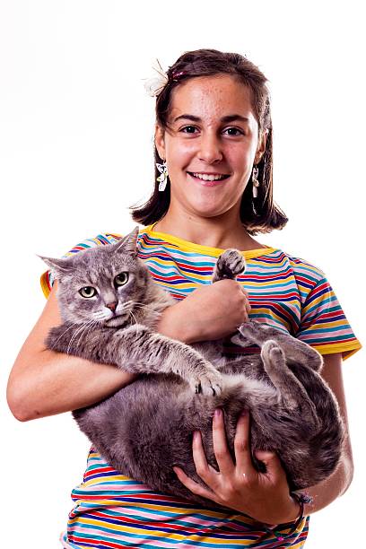istock smiling little girl with her cat 493326331
