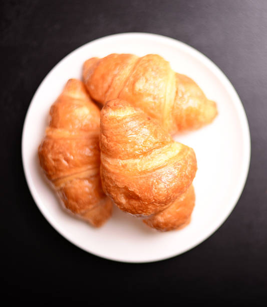 istock Fresh and tasty croissant on blackboard 493332306