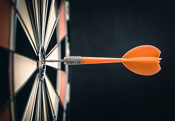 Darts Darts in bull's-eye darts stock pictures, royalty-free photos & images
