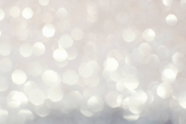 istock Silver white glittering Christmas lights. Blurred abstract backg 493334942