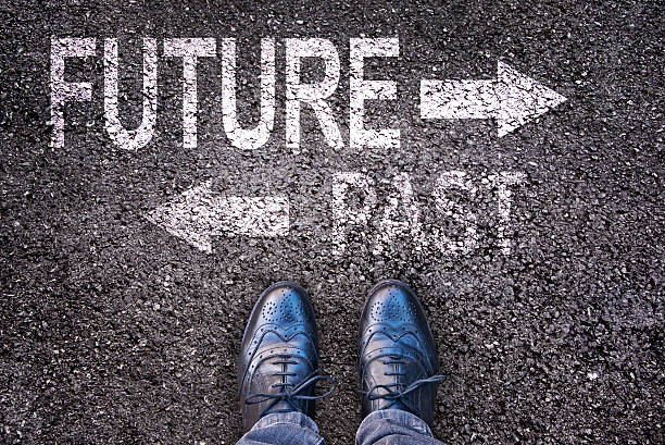 Feet and words future and past  on an alphalt road