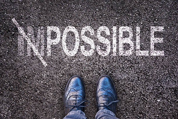istock Changing the word impossible on possible on an aspahlt road 493338138