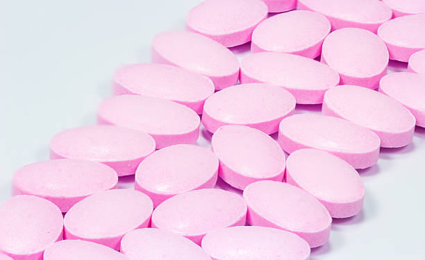 istock The pink tablets isolated on white background 493338764