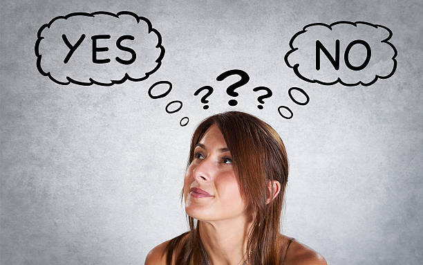 istock Portrait of smiling woman thinking with interogation point 493340044
