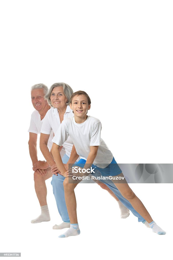 Grandparents with boy Happy grandparents exercising with boy on a white background 2015 Stock Photo