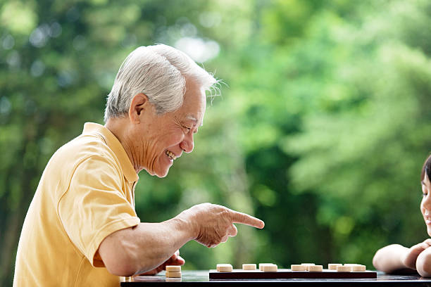 istock Grandfather and grandson playing Xiangqi (chinese chess) 493373337