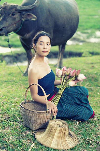istock thai ancient young women with buffalo on rural 493373440