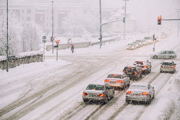 istock Urban traffic on the street in snowfall 493374306