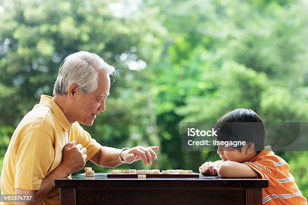 Grandfather And Grandson Playing Xiangqi Stock Photo - Download Image Now