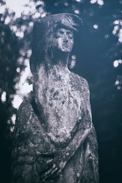 Tender romantic stone statue of a melancholic woman. Cemetery
