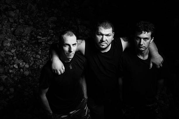 deep looks of them black and white photo with rock band members looking with cool attitude at camera. boy band stock pictures, royalty-free photos & images