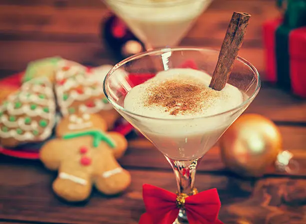 Eggnog with Cinnamon and Nutmeg at Christmas Time in front of the fireplace