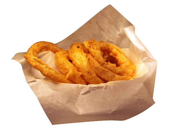 istock Onion rings on brown paper.  Isolated on white.  Copy space. 493378055