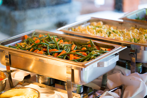 Catering meal at a wedding reception of green beans and carrots.