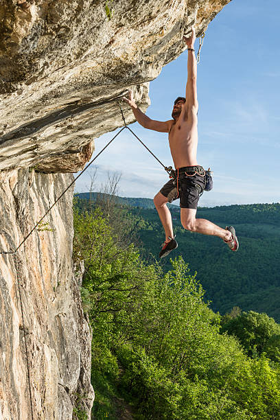 istock one young rock climber outdoor in a difficul overhang 493378741