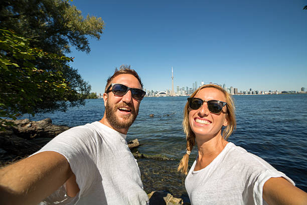 istock Young couple taking selfie portrait in Toronto-Summer 493379472