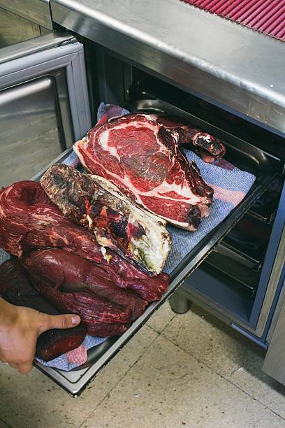 istock Cook taking a tray of meat from the refrigerator 493380128