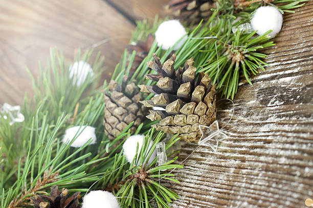 istock Colorful fir tree toys, pine cones, coniferous branches on Woode 493380780