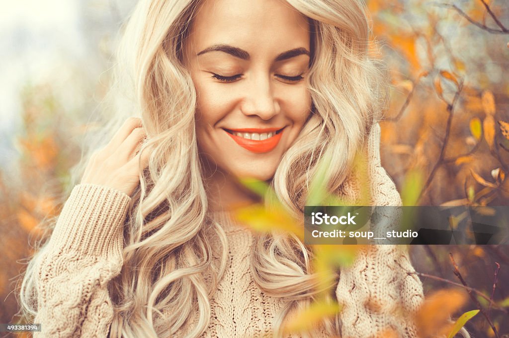 Beautiful lady surrounded autumn leaves Outdoor fashion photo of young beautiful lady surrounded autumn leaves Autumn Stock Photo