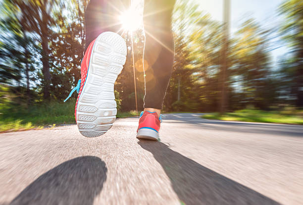 istock Woman runner jogging down the road 493383214