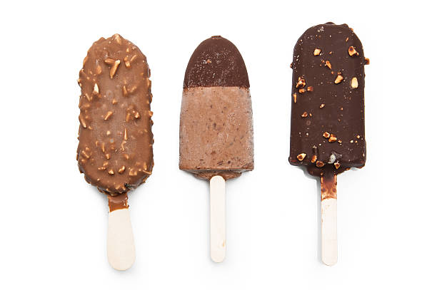 istock chocolate dipped popsicles with coconut and nuts. Overhead view 493384510